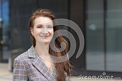 Kind adult woman. mature middle age businesswoman smiling. lady with long brunette ginger hair with smile. positive professional, Stock Photo