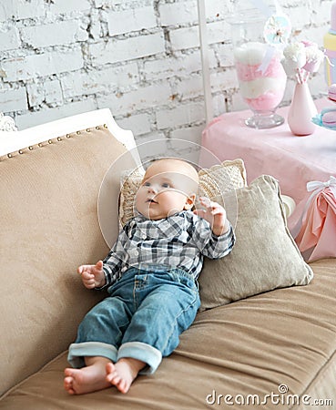 Portrait of a happy little boy laying on the sofa Stock Photo