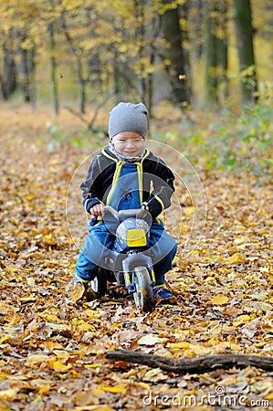 Portrait of a happy little boy riding a motorbike Stock Photo