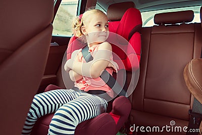 Portrait of happy little child girl sitting comfortable in car s Stock Photo