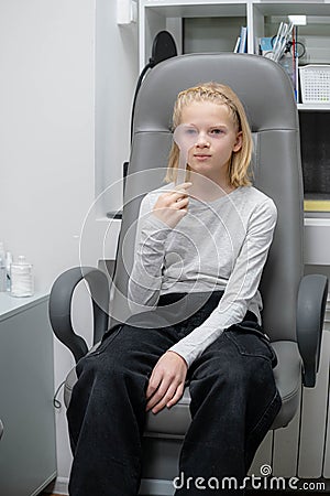 portrait happy little girl patient ophthalmology clinic, vision test in progress cheerful child an optometric Stock Photo
