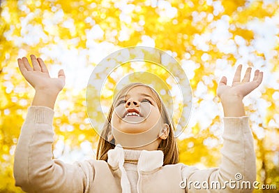 Portrait of a happy little girl playing with autumn leaves Stock Photo