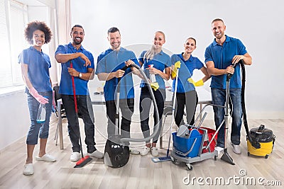 Portrait Of Happy Male And Female Janitors Stock Photo
