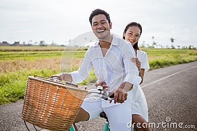 happy man and woman cycling outdoor smiling to camera Stock Photo