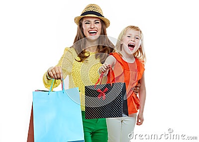 Portrait of happy mother and daughter showing shopping bags Stock Photo
