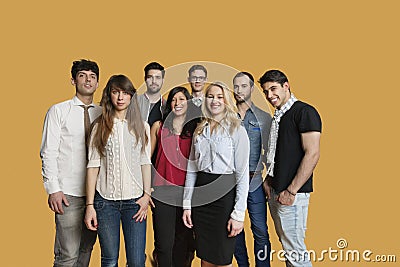 Portrait of happy multiethnic group of friends standing together over colored background Stock Photo