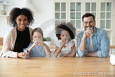 Portrait of happy multiracial family recommend drinking water Stock Photo