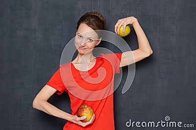 Portrait of happy optimistic girl holding apples in hands and smiling Stock Photo