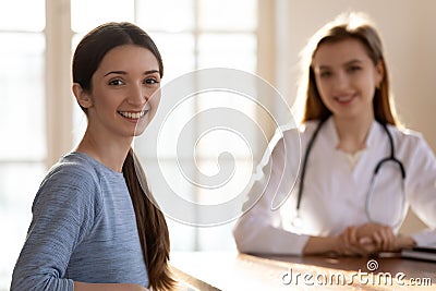 Portrait of happy patient in office of capable qualified doctor Stock Photo