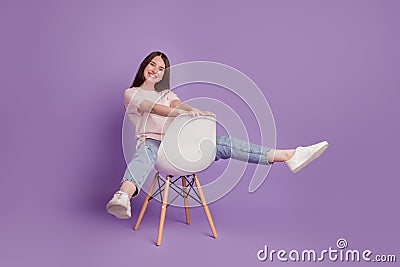 Portrait of happy positive girl sit chair have fun carefree mood raise legs Stock Photo