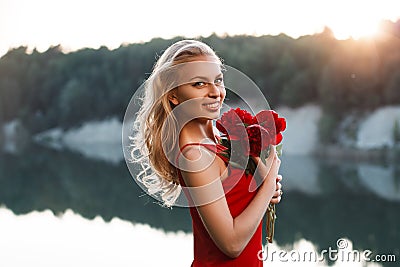 Portrait of a happy pretty woman with a bouquet of peony. On the Stock Photo