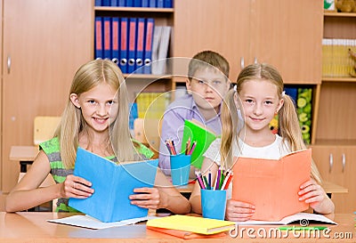 Portrait of happy school children with books Stock Photo