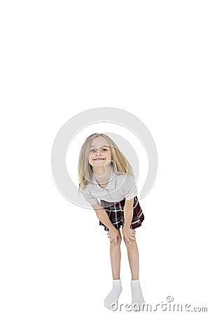 Portrait of happy school girl bending over white background Stock Photo