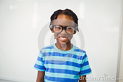 Portrait of happy schoolboy smiling in classroom Stock Photo