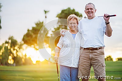 Portrait of happy senior couple playing golf enjoying retirement Stock Photo