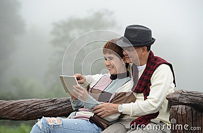 Romantic senior couples using digital tablet Stock Photo