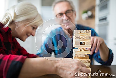 Happy senior marriage playing jenga together Stock Photo