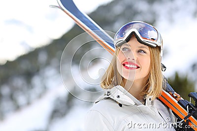 Happy skier looking above in the mountain Stock Photo