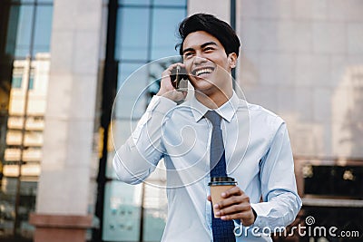 Portrait of a Happy Smiling Businessman Talking on Mobile Phone in the Urban City. Lifestyle of Modern People Stock Photo