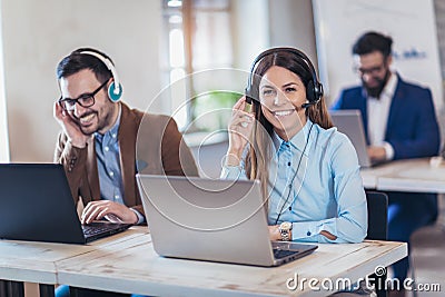 Portrait of happy smiling female customer support phone operator Stock Photo