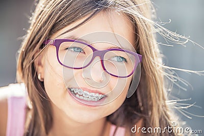 Portrait of happy smiling girl with dental braces and glasses Stock Photo