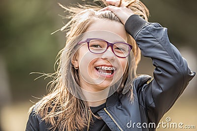 Portrait of a happy smiling teenage girl with dental braces and glasses Stock Photo