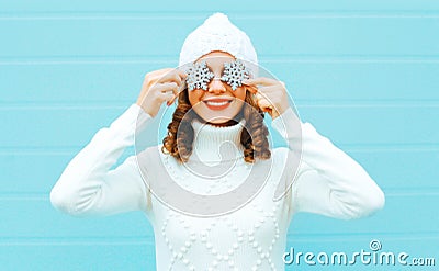 Portrait happy smiling woman holds snowflakes closes her eye Stock Photo