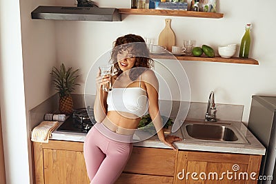 Portrait Of Happy Smiling Young Woman With Glass Of Fresh Water Stock Photo