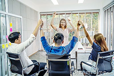 Portrait Of Happy Successful Business Group at office,.Business team celebrating a triumph with arms up, Stock Photo