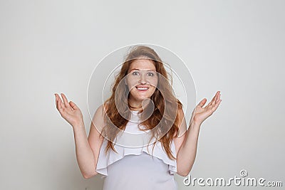 Portrait of happy surprised woman shacking her hands on white background Stock Photo