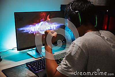 Portrait of happy teenage gamer boy winning while playing video Stock Photo