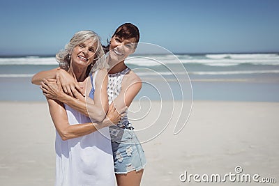 Portrait of happy woman with her mother standing at beach Stock Photo