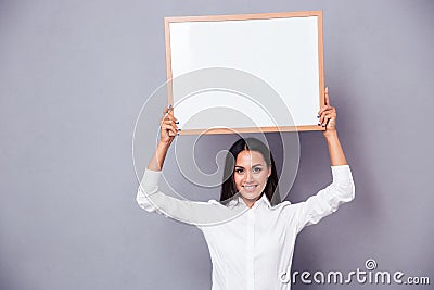 Portrait of a happy woman holding blank board on head Stock Photo