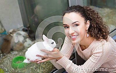 Portrait of happy woman holding rabbit Stock Photo