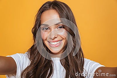 Portrait of happy woman 20s with long hair laughing while taking Stock Photo