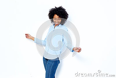 Happy young african woman dancing and enjoying against white background Stock Photo