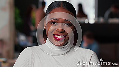 Portrait of happy young beautiful 20s gen-z black business woman with red lips smiling at camera at light trendy office. Stock Photo