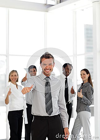 Portrait of a happy young businessman thumbs-up Stock Photo