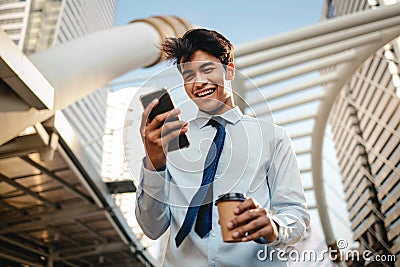 Portrait of a Happy Young Businessman Using Mobile Phone in the Urban City. Stock Photo