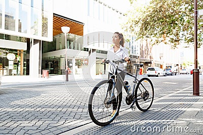 Portrait of happy young female bicyclist Stock Photo