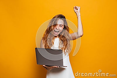 Portrait of a happy young girl holding laptop computer Stock Photo