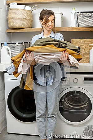 Portrait of a happy young housewife with clean clothes Stock Photo