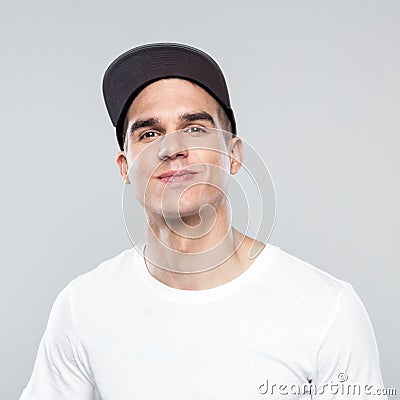 Portrait of happy young man in baseball cap Stock Photo
