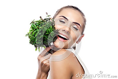 Portrait of happy young woman with a bundle of fresh mint Stock Photo