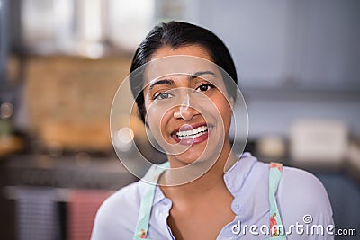 Portrait of happy young woman with flour on nose Stock Photo