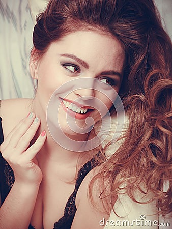 Portrait of happy young woman in lingerie in bed. Stock Photo