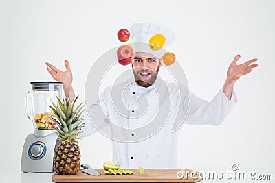 Portrait of a hapy male chef cook juggle with fruits Stock Photo