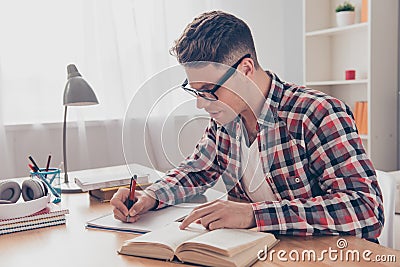 Portrait of hardworking student with book preparing for test in university Stock Photo