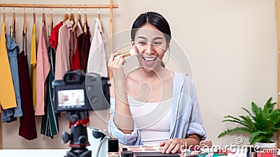 Portrait or headshot of attractive young asian influencer, beauty blogger, content creator or vlogger girl review make up looking Stock Photo
