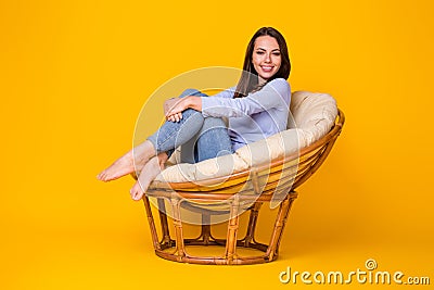 Portrait of her nice attractive lovely carefree glad cheerful girl sitting in cosy comfy wicker chair enjoying weekend Stock Photo